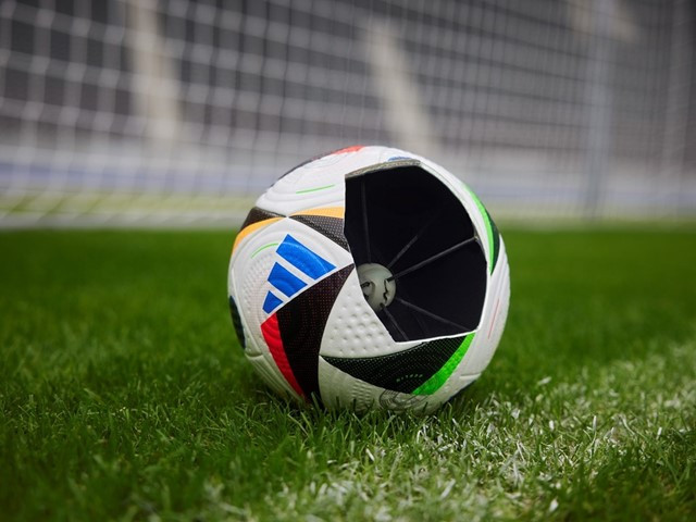 Close-up of the Adidas FUSSBALLLIEBE official match ball for Euro 2024, showcasing its vibrant design and panel construction.