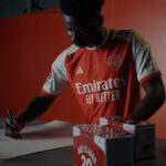 Arsenal soccer star Bukayo Saka signs posters for fans' treasure hunt