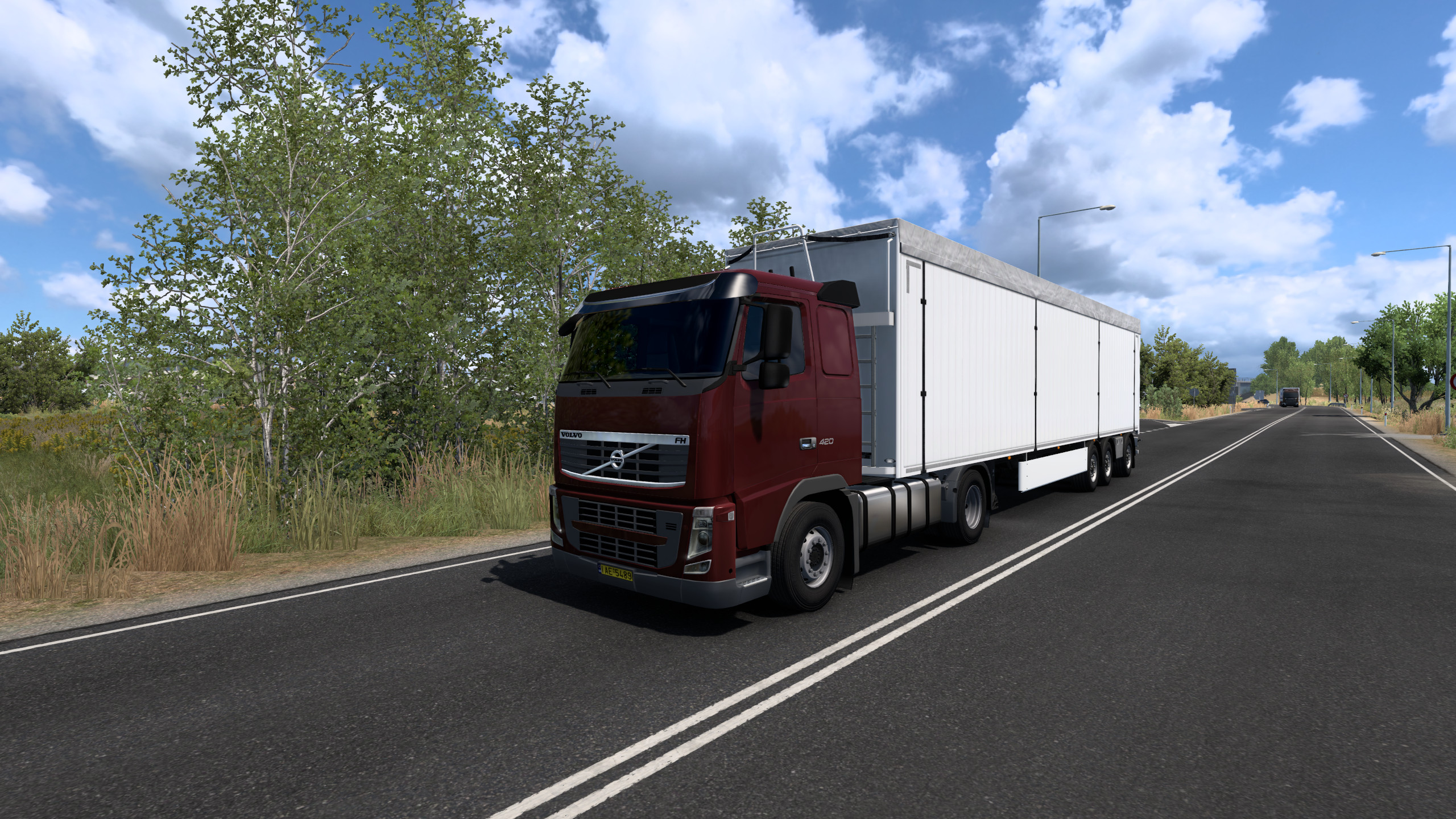 Euro Truck Simulator 2 gameplay showing a truck driving on a road at night