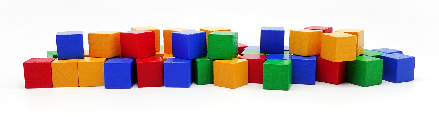 Wooden cube game pieces in various colors, commonly used abstract components in Euro games