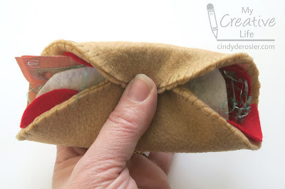 Layering euro bills and felt toppings into the felt pita