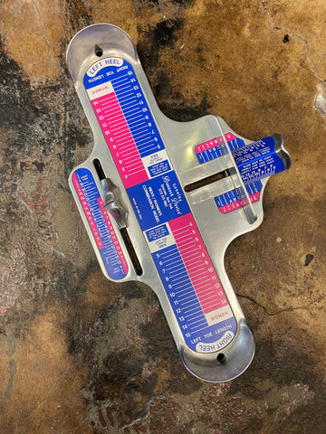 Man using a Brannock device to measure shoe size