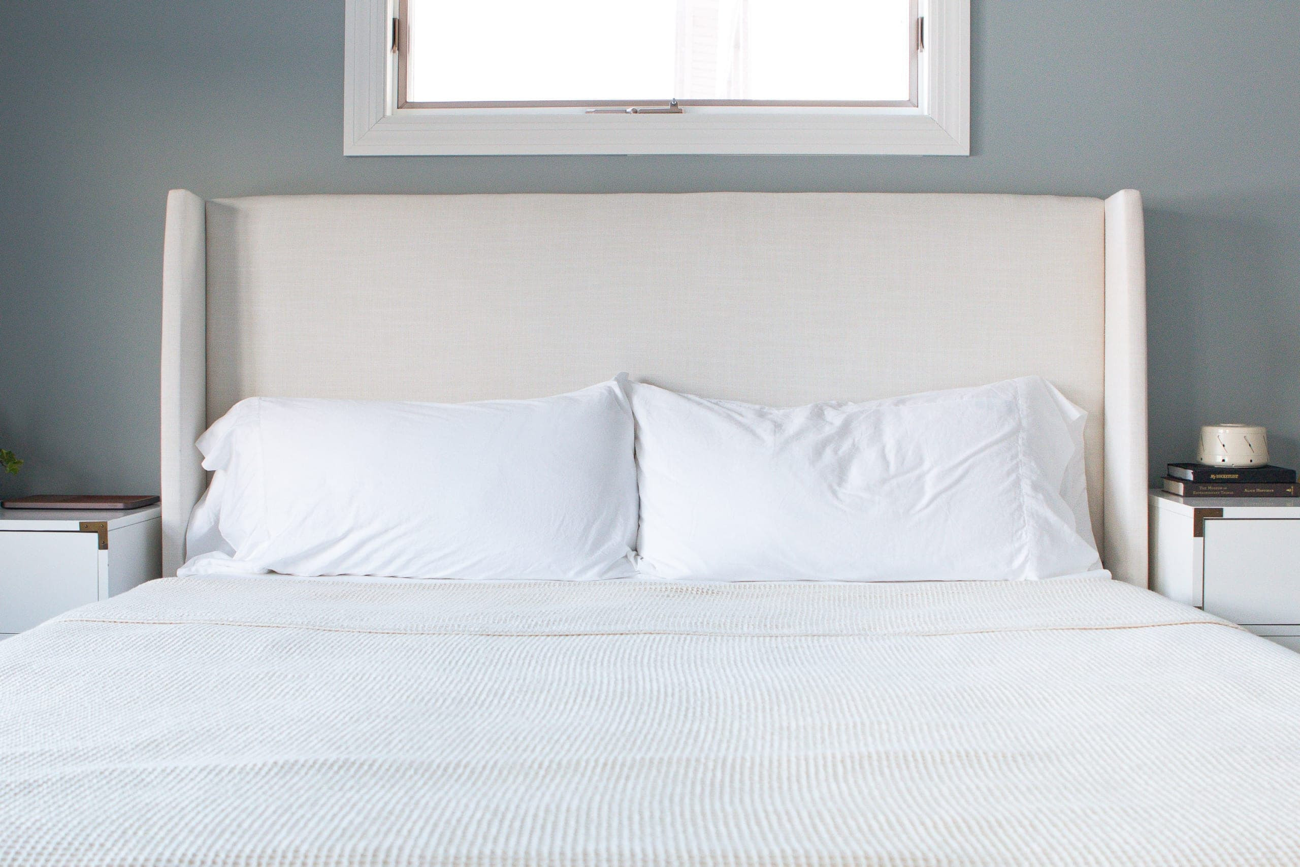 King size pillows in white pillowcases on a made king bed