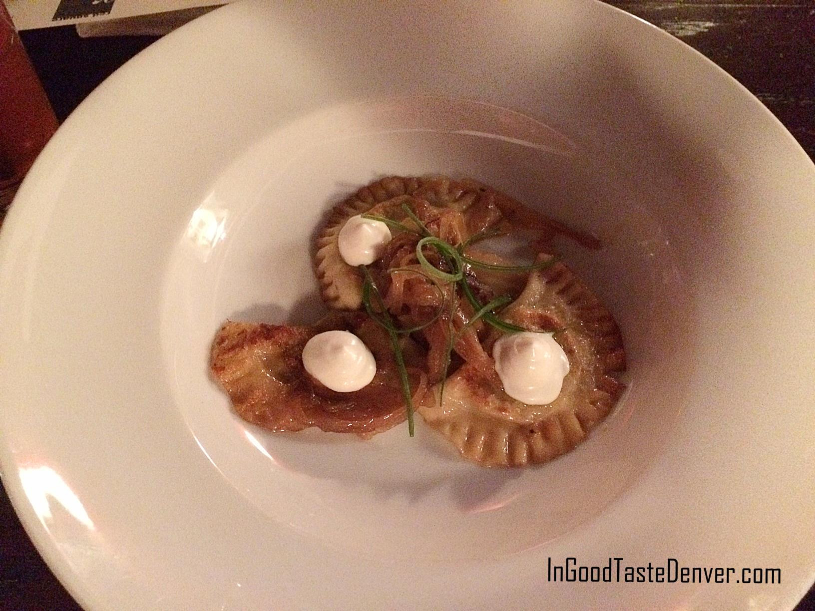 Close-up of warm and crispy pierogies filled with fava bean, mushroom, and ricotta cheese, showcasing Red Square Euro Bistro Denver's comforting European cuisine