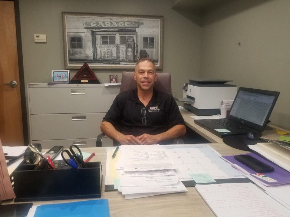 Tony Magliolo, Owner of Euro Auto Body, standing proudly in his shop