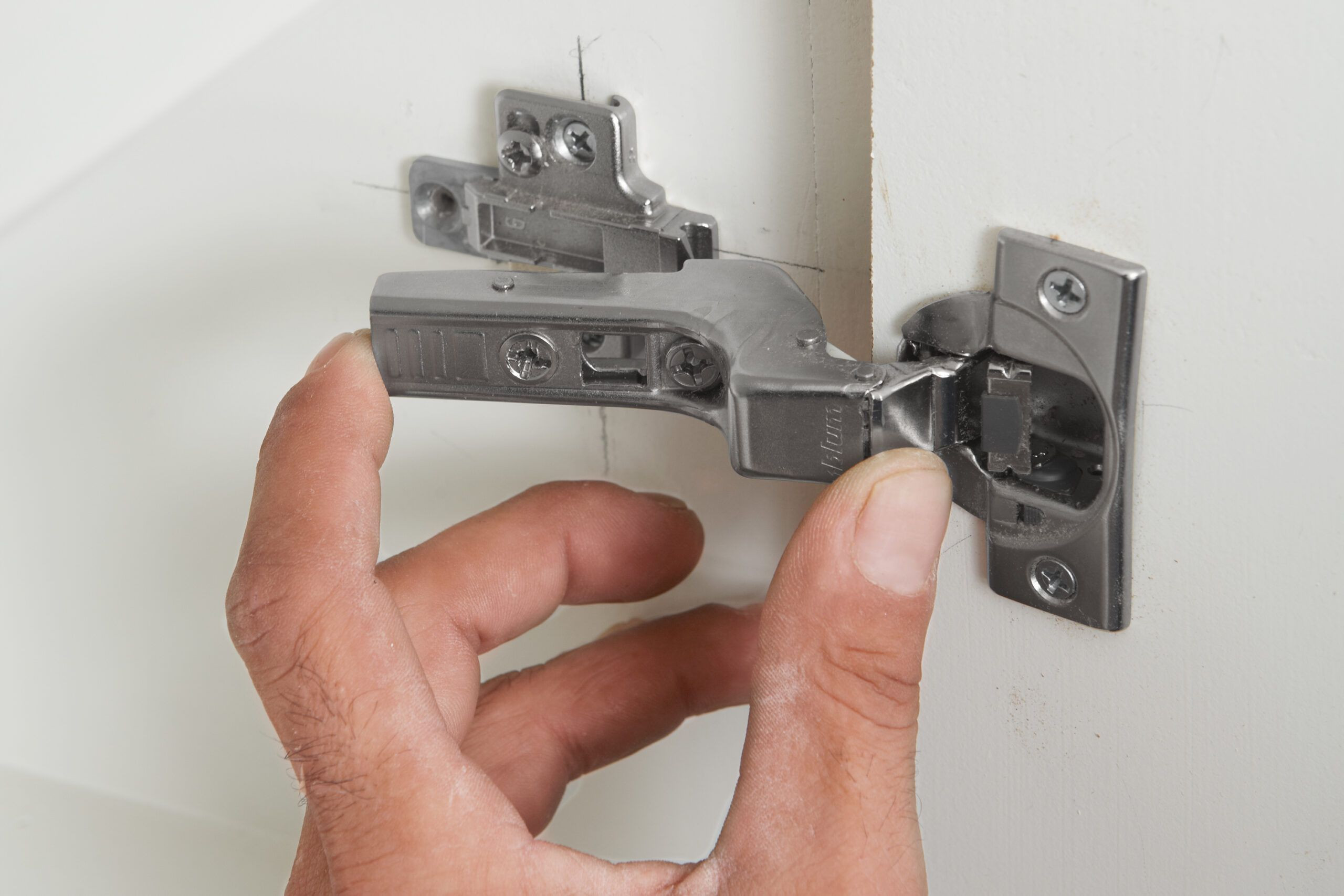 The cabinet doors are hung once the hinges and mounts are in place.