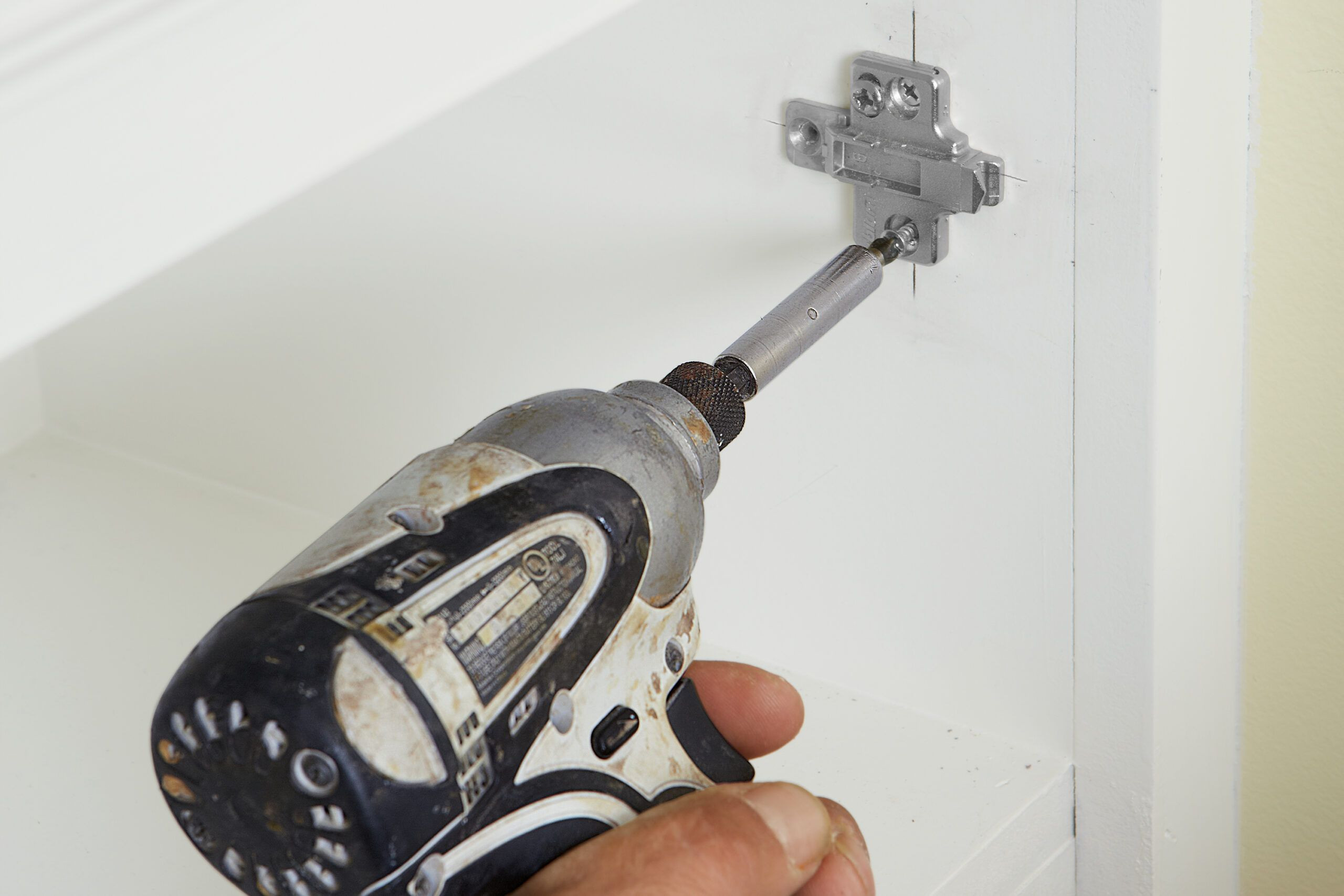 A mounting plate is drilled inside the cabinet.